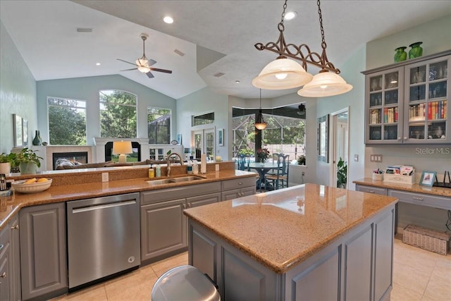 kitchen with stainless steel dishwasher, a sink, ceiling fan, gray cabinets, and light tile patterned floors