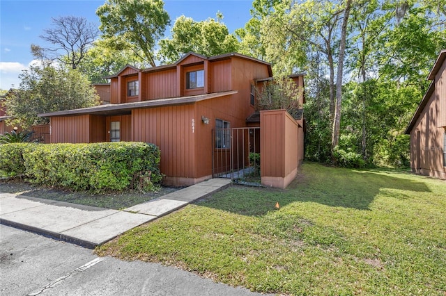 5841 SW 8th Pl, Gainesville, FL 32607 - view of property exterior featuring a yard and a gate
