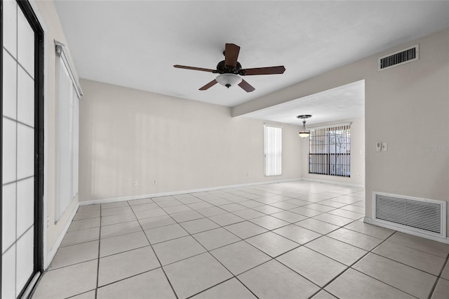 5841 SW 8th Pl, Gainesville, FL 32607 - unfurnished room with a ceiling fan, light tile patterned floors, and baseboards