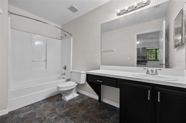 5841 SW 8th Pl, Gainesville, FL 32607 - full bathroom with toilet,  shower combination, vanity, stone finish flooring, and baseboards
