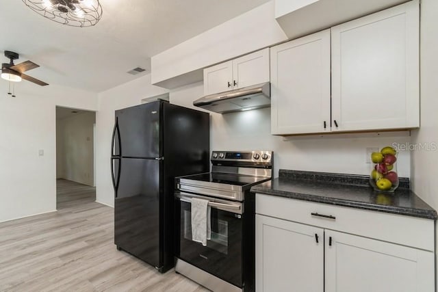 2911 NE 17th Ter, Gainesville, FL 32609 - kitchen with stainless steel range with electric stovetop, under cabinet range hood, freestanding refrigerator, light wood-style floors, and white cabinets
