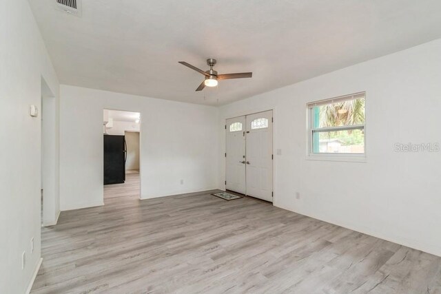 2911 NE 17th Ter, Gainesville, FL 32609 - foyer with light wood-style flooring, a ceiling fan, and baseboards