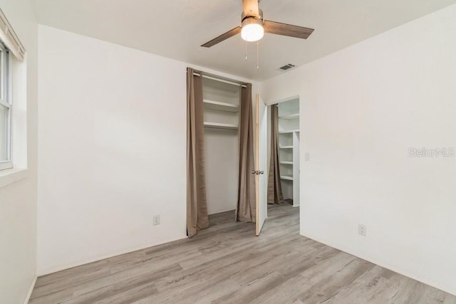 2911 NE 17th Ter, Gainesville, FL 32609 - unfurnished bedroom with light wood finished floors, a closet, and ceiling fan