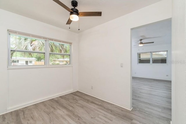 2911 NE 17th Ter, Gainesville, FL 32609 - unfurnished room with ceiling fan, wood finished floors, and plenty of natural light