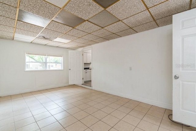2911 NE 17th Ter, Gainesville, FL 32609 - spare room with a paneled ceiling, baseboards, and light tile patterned flooring