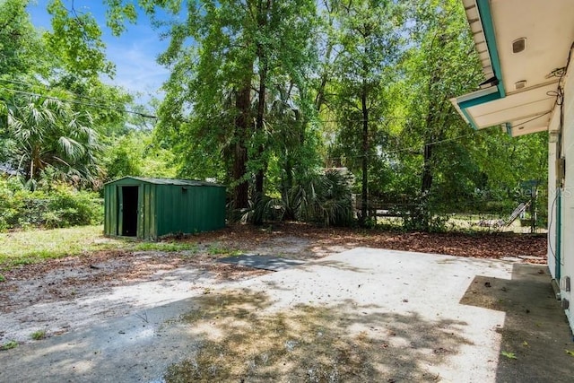 2911 NE 17th Ter, Gainesville, FL 32609 - view of yard featuring a patio area, a storage unit, and an outbuilding