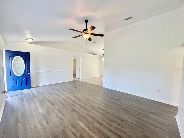 24409 NW 25th Pl, Newberry, FL 32669 - unfurnished living room with a ceiling fan, lofted ceiling, wood finished floors, and baseboards