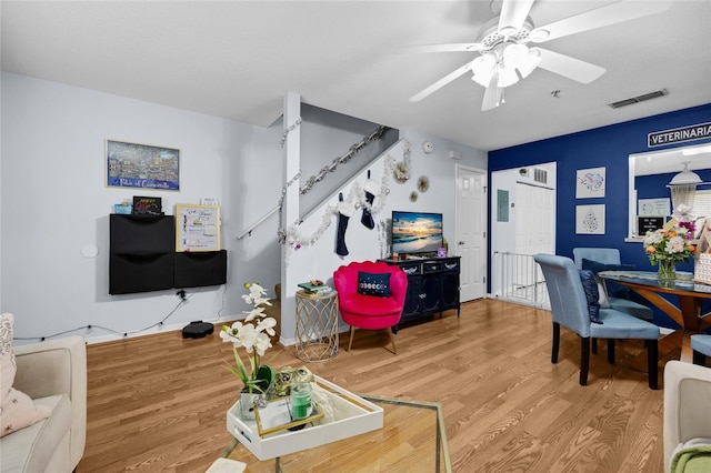 2636 SW 35th Pl Unit 21, Gainesville, FL 32608 - living room featuring wood finished floors, a ceiling fan, and stairs