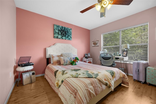 2636 SW 35th Pl Unit 21, Gainesville, FL 32608 - bedroom with wood finished floors, baseboards, and a ceiling fan