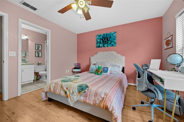 2636 SW 35th Pl Unit 21, Gainesville, FL 32608 - bedroom with wood finished floors, a desk, ensuite bathroom, and a ceiling fan