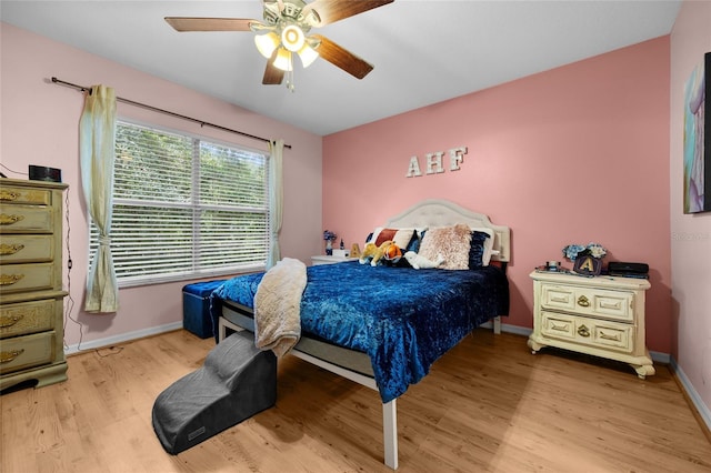 2636 SW 35th Pl Unit 21, Gainesville, FL 32608 - bedroom featuring wood finished floors, baseboards, and a ceiling fan