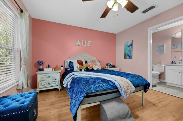 2636 SW 35th Pl Unit 21, Gainesville, FL 32608 - bedroom with wood finished floors, ensuite bath, and a ceiling fan