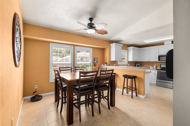 1979 NW 86th Ter, Gainesville, FL 32606 - dining room featuring ceiling fan, baseboards, vaulted ceiling, and light tile patterned flooring