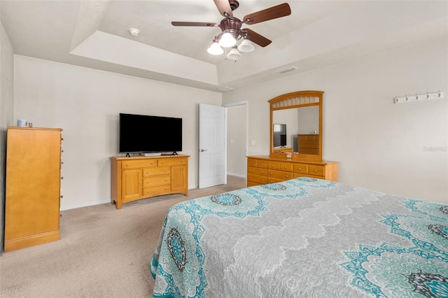 1979 NW 86th Ter, Gainesville, FL 32606 - bedroom with a tray ceiling, light colored carpet, baseboards, and a ceiling fan