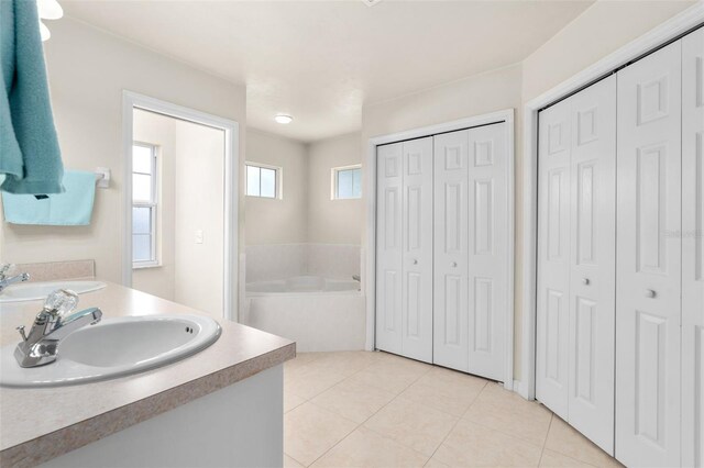 1979 NW 86th Ter, Gainesville, FL 32606 - bathroom featuring a closet, a bath, tile patterned floors, and vanity