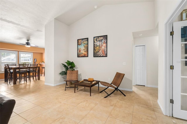 1979 NW 86th Ter, Gainesville, FL 32606 - sitting room featuring light tile patterned floors, ceiling fan, baseboards, and high vaulted ceiling