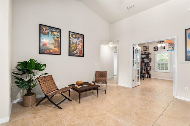 1979 NW 86th Ter, Gainesville, FL 32606 - sitting room featuring high vaulted ceiling, light tile patterned floors, a ceiling fan, and baseboards