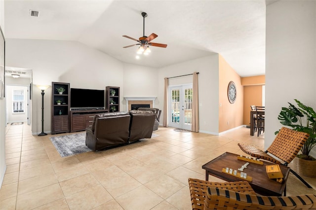 1979 NW 86th Ter, Gainesville, FL 32606 - living area with light tile patterned floors, ceiling fan, lofted ceiling, a fireplace, and baseboards