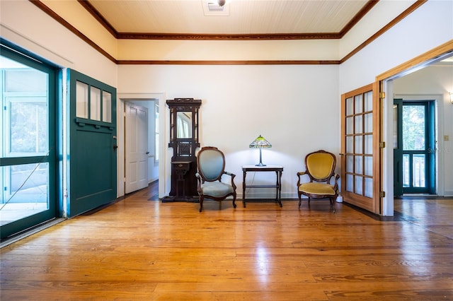 502 NE Cholokka Blvd, Micanopy, FL 32667 - entryway with ornamental molding, healthy amount of natural light, light wood-style flooring, and baseboards