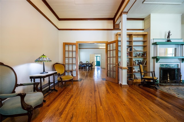 502 NE Cholokka Blvd, Micanopy, FL 32667 - sitting room featuring french doors, ornamental molding, wood finished floors, and a fireplace
