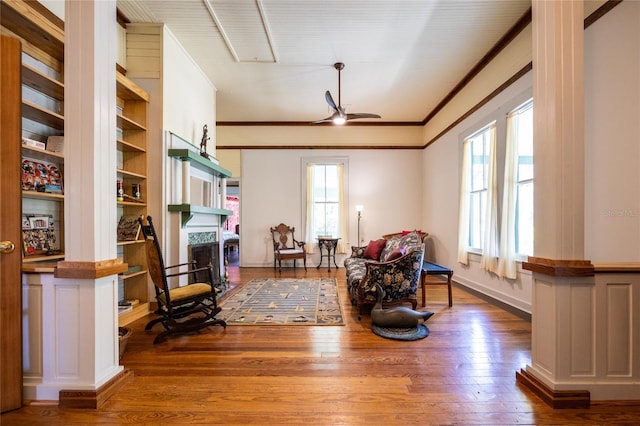 502 NE Cholokka Blvd, Micanopy, FL 32667 - sitting room with a fireplace, hardwood / wood-style flooring, ornamental molding, a ceiling fan, and baseboards