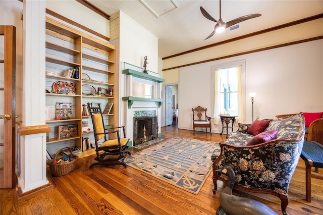 502 NE Cholokka Blvd, Micanopy, FL 32667 - living room featuring a high end fireplace, wood-type flooring, ceiling fan, and ornamental molding