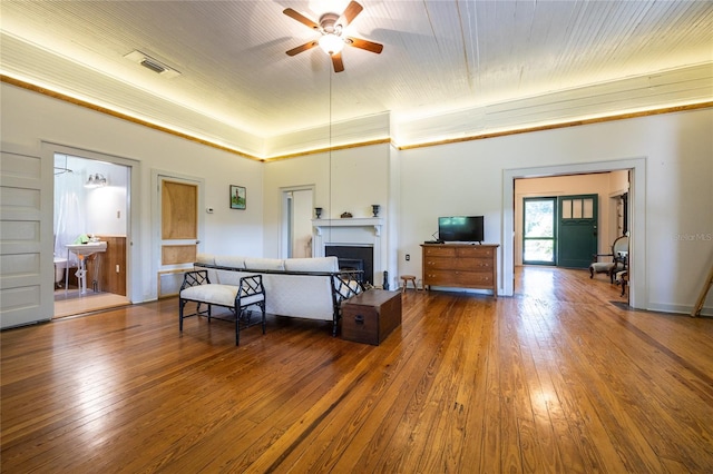 502 NE Cholokka Blvd, Micanopy, FL 32667 - living area featuring a ceiling fan, a fireplace, and wood-type flooring