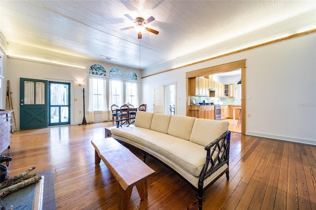 502 NE Cholokka Blvd, Micanopy, FL 32667 - living room featuring ceiling fan, hardwood / wood-style floors, and baseboards