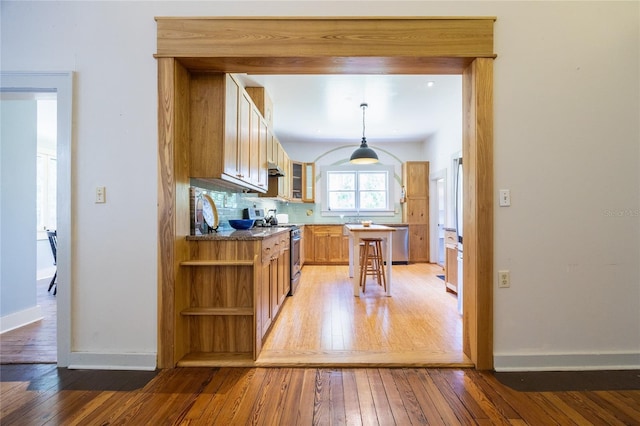 502 NE Cholokka Blvd, Micanopy, FL 32667 - kitchen with appliances with stainless steel finishes, light wood-style floors, baseboards, and open shelves