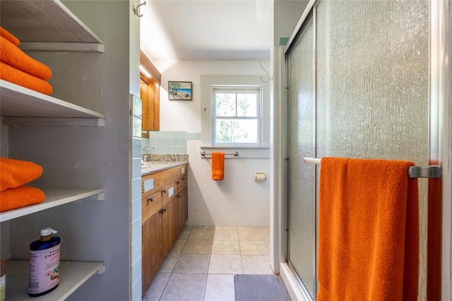 502 NE Cholokka Blvd, Micanopy, FL 32667 - full bath with vanity, a shower stall, tile patterned floors, and tile walls
