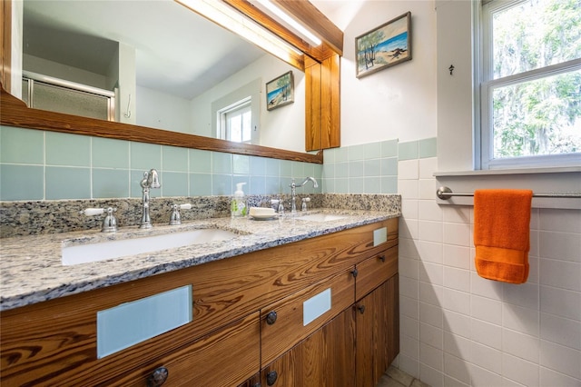 502 NE Cholokka Blvd, Micanopy, FL 32667 - bathroom featuring tile walls and double vanity