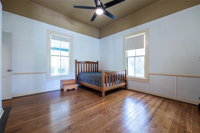 502 NE Cholokka Blvd, Micanopy, FL 32667 - bedroom with multiple windows, hardwood / wood-style flooring, a ceiling fan, and baseboards