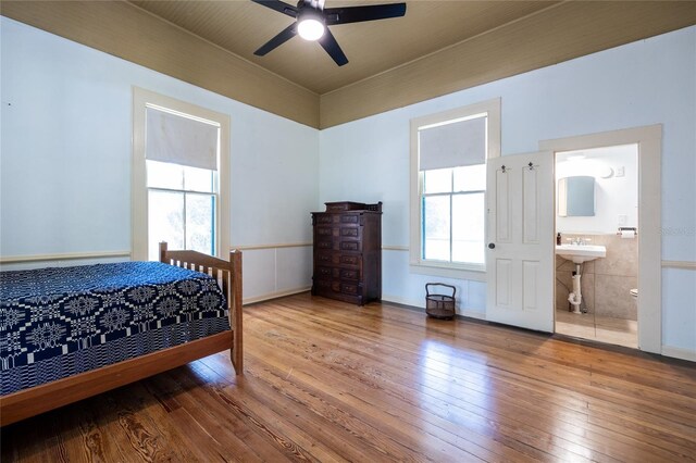 502 NE Cholokka Blvd, Micanopy, FL 32667 - bedroom with hardwood / wood-style flooring, a ceiling fan, and connected bathroom