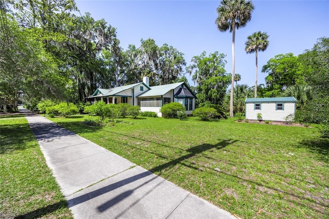 502 NE Cholokka Blvd, Micanopy, FL 32667 - view of property exterior with a yard, an outbuilding, and a chimney