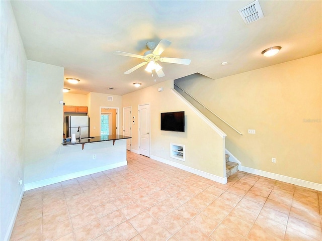 2964 SW 35th Pl Unit 75, Gainesville, FL 32608 - unfurnished living room with ceiling fan, stairway, light tile patterned flooring, and baseboards
