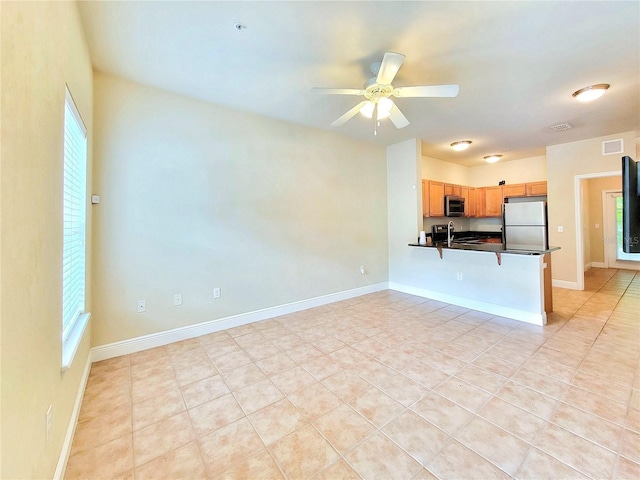 2964 SW 35th Pl Unit 75, Gainesville, FL 32608 - unfurnished living room featuring plenty of natural light, a sink, ceiling fan, and light tile patterned flooring