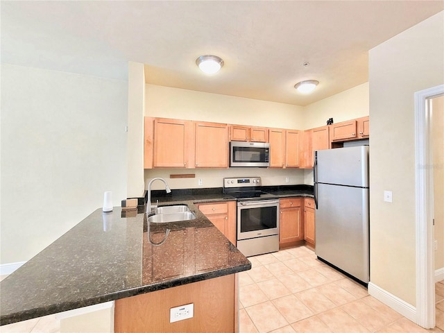 2964 SW 35th Pl Unit 75, Gainesville, FL 32608 - kitchen featuring appliances with stainless steel finishes, a sink, a peninsula, and light brown cabinets