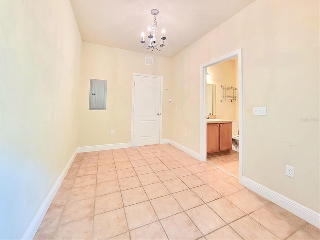 2964 SW 35th Pl Unit 75, Gainesville, FL 32608 - unfurnished room with electric panel, a chandelier, a sink, light tile patterned floors, and baseboards