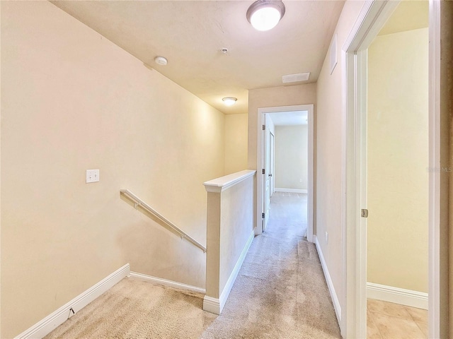 2964 SW 35th Pl Unit 75, Gainesville, FL 32608 - hall with an upstairs landing, baseboards, and light colored carpet