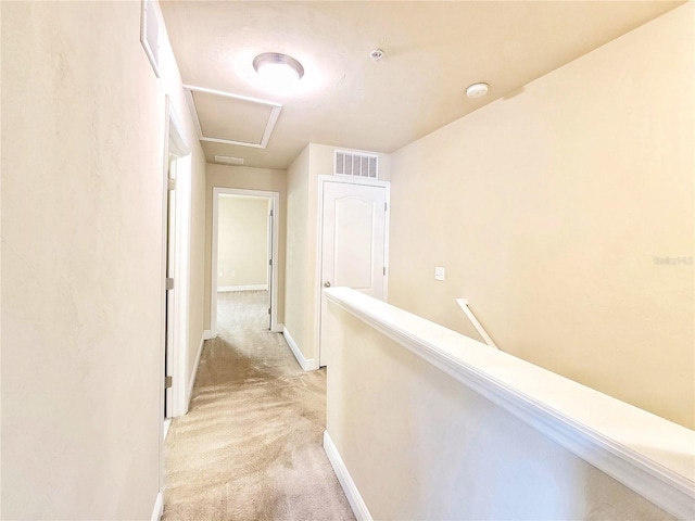 2964 SW 35th Pl Unit 75, Gainesville, FL 32608 - hallway featuring light carpet, an upstairs landing, baseboards, and attic access