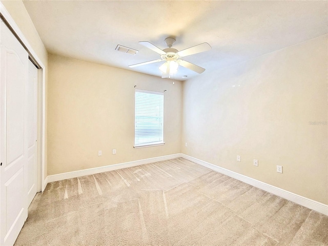 2964 SW 35th Pl Unit 75, Gainesville, FL 32608 - unfurnished bedroom featuring baseboards, a closet, light colored carpet, and ceiling fan