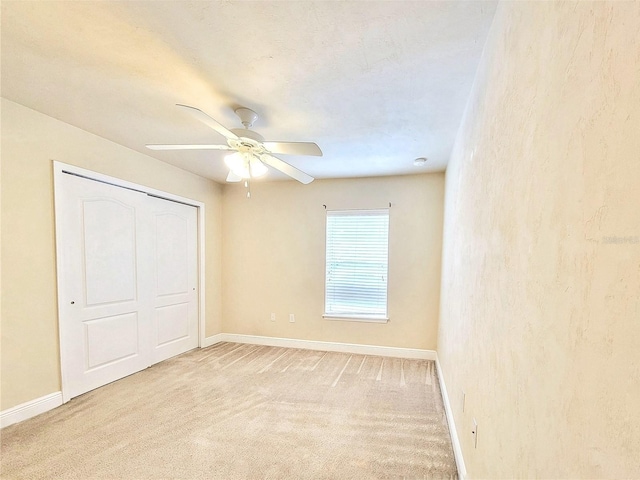 2964 SW 35th Pl Unit 75, Gainesville, FL 32608 - unfurnished bedroom featuring baseboards, light colored carpet, and a ceiling fan