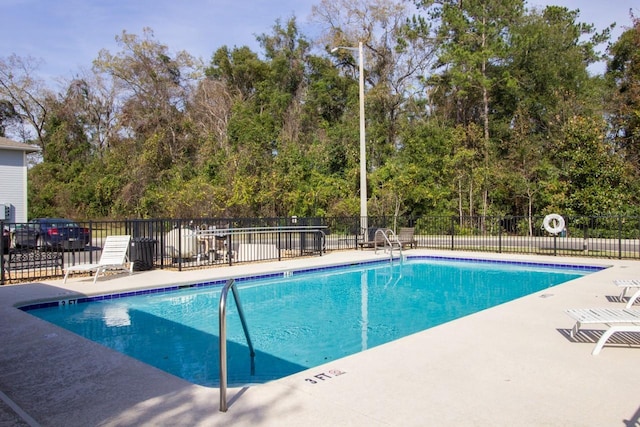 2964 SW 35th Pl Unit 75, Gainesville, FL 32608 - community pool featuring fence, a patio, and view of wooded area