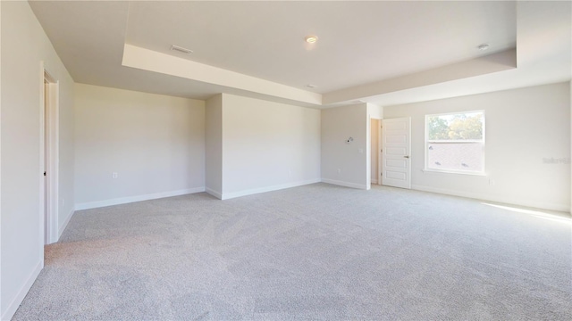 3279 E Iris Ln, Bell, FL 32619 - empty room featuring light carpet, a raised ceiling, and baseboards