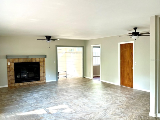 532 NE 7th Ter, Gainesville, FL 32601 - unfurnished living room with a ceiling fan, stone finish floors, a fireplace, and baseboards