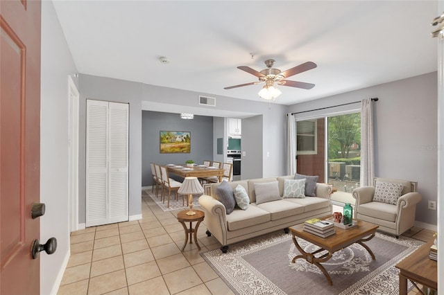 2360 SW Archer Rd Unit 1102, Gainesville, FL 32608 - living room with ceiling fan, baseboards, and light tile patterned floors