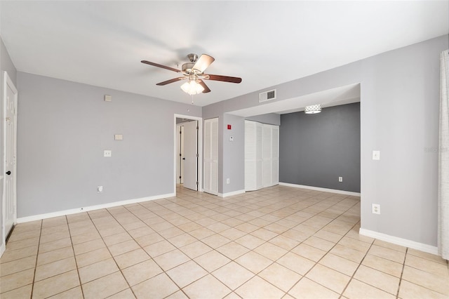 2360 SW Archer Rd Unit 1102, Gainesville, FL 32608 - spare room featuring a ceiling fan, baseboards, and light tile patterned flooring