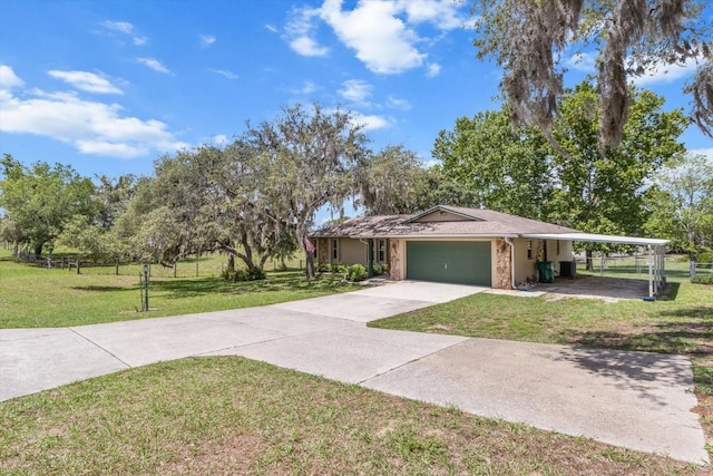 1786 S Border Ave, Inverness, FL 34452 - view of front of home with an attached garage, a front lawn, concrete driveway, and a carport