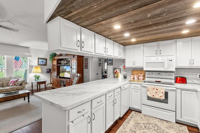 1786 S Border Ave, Inverness, FL 34452 - kitchen featuring white appliances, open floor plan, a peninsula, wooden ceiling, and white cabinets