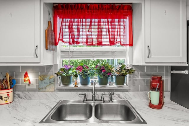 1786 S Border Ave, Inverness, FL 34452 - kitchen view of a sink, white cabinetry, and backsplash